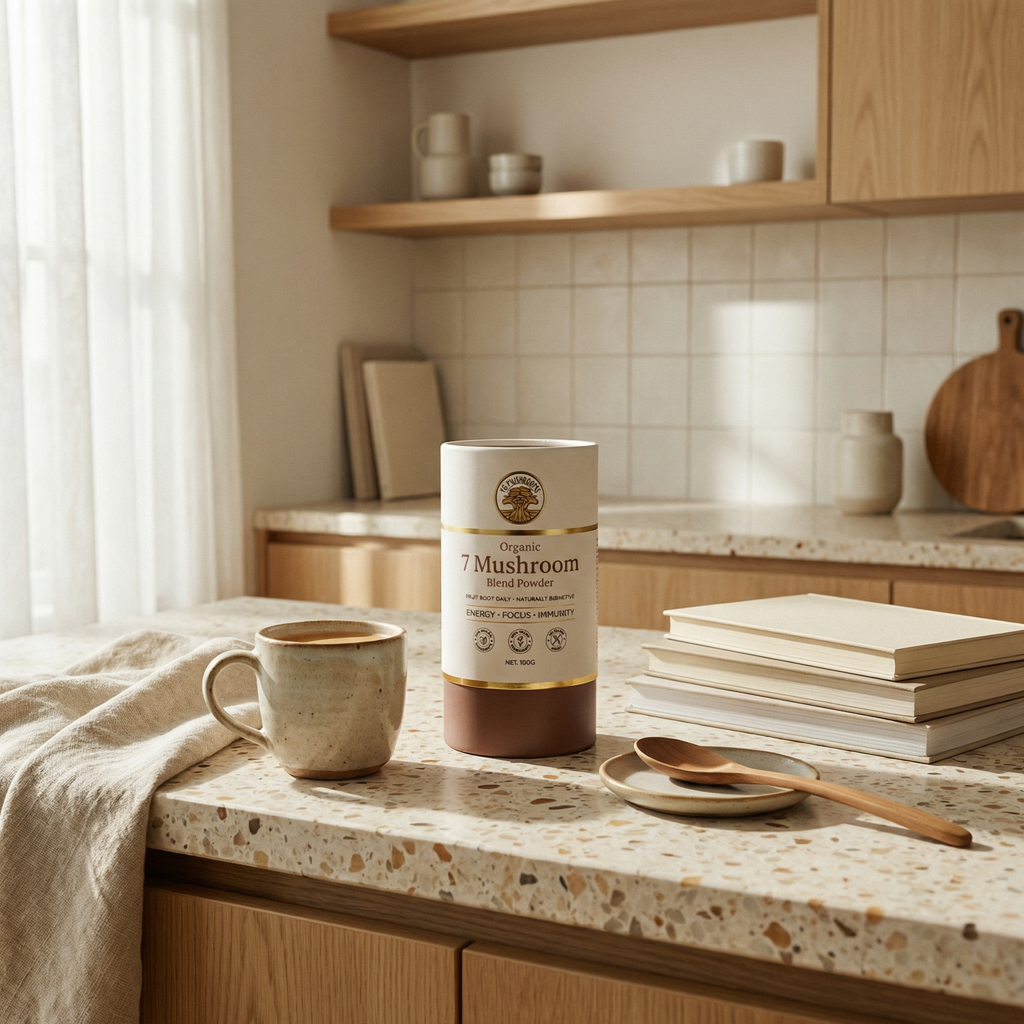 Container of 7 Mushroom Blend Powder on a kitchen counter with a cup and books.